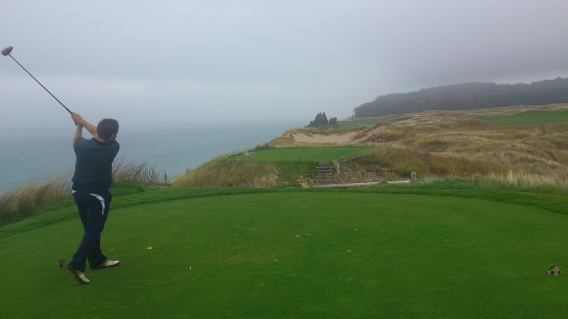Chris, driving a golf ball into Lake Michigan