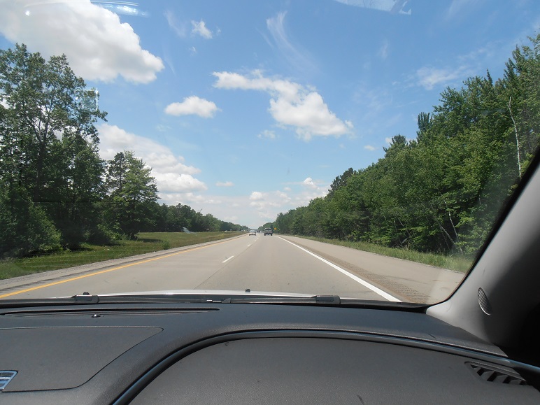 Photo of the open road through Michigan, taken through a car windscreen