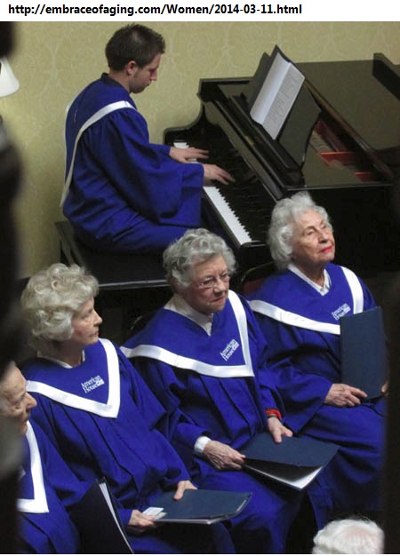 Chris in A.H. robe giving piano accompaniment to a choir